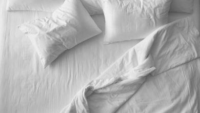 A clean white bedset with deep pocket sheets placed on it