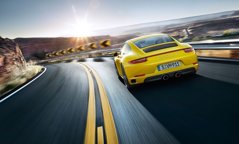 A sleek Porsche 911 gts cruises on the road, showcasing car engine powerful performance and elegant design